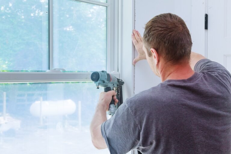 worker-installing-trim-around-a-window-molding-installed-moldings-materials